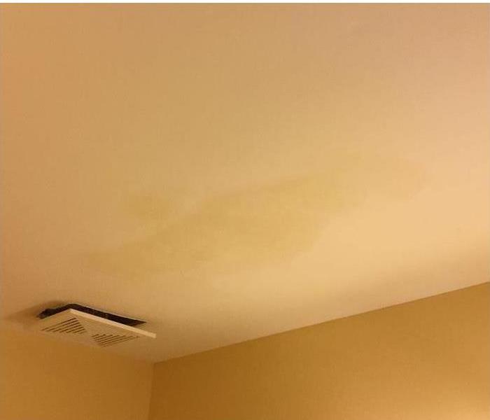 water stains on a ceiling, with the a/c register hanging