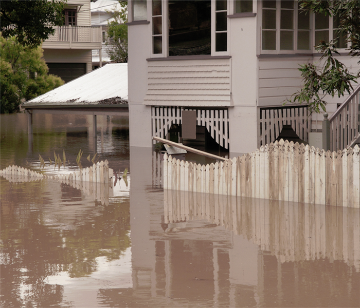 a flooded neighborhood with water up to the first level of a house